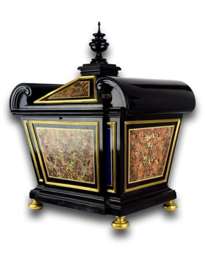 A fine ebony veneered casket inset with ormolu framed panels of Sicilian jasper & lapis lazuli, within borders of black & white marbles. Raised on ormolu feet, the casket has a concealed latch to open & remove the compartment door. Italian, around c.1700. Measures 53cm high x 43cm wide x 33cm deep.