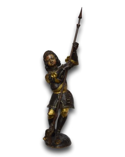 A polychromed limewood sculpture of Saint George slaying the dragon. The lance is a 19th century addition. Southern Germany, probably Ulm, mid 16th century. Measures 89cm total height.